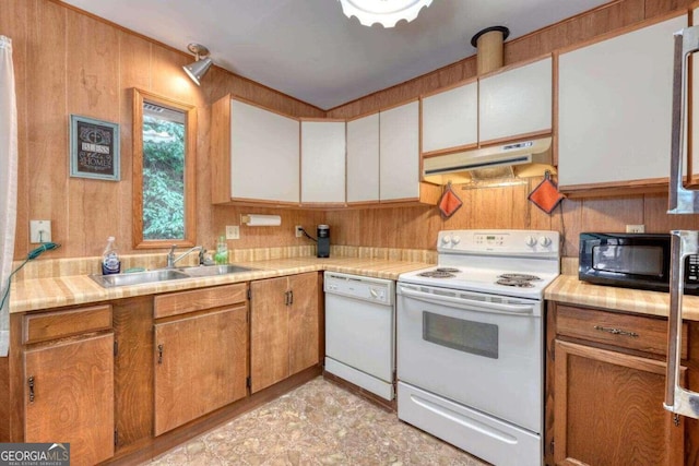 kitchen featuring sink, white appliances, white cabinets, and light tile patterned floors