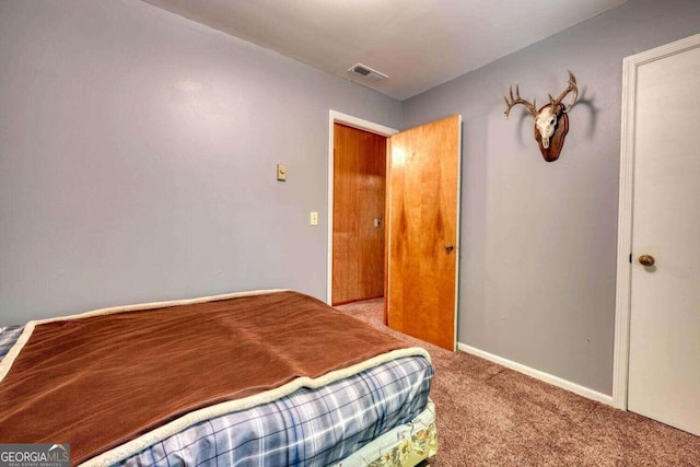 bedroom with visible vents, baseboards, and carpet