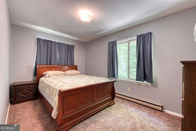 carpeted bedroom featuring a baseboard heating unit