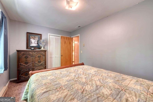 bedroom with carpet, visible vents, a closet, and baseboards