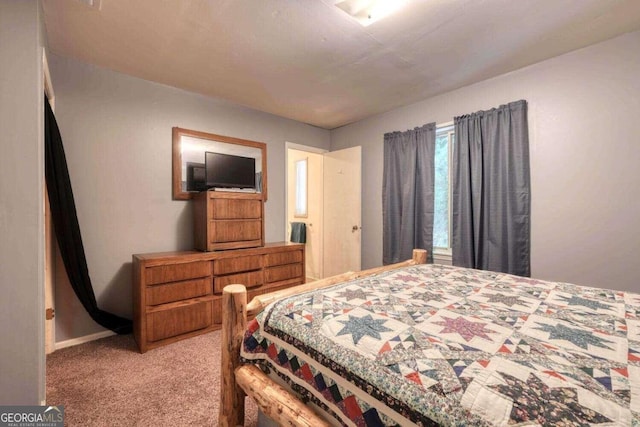 bedroom featuring baseboards and light colored carpet