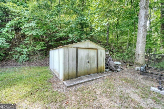view of shed with a wooded view