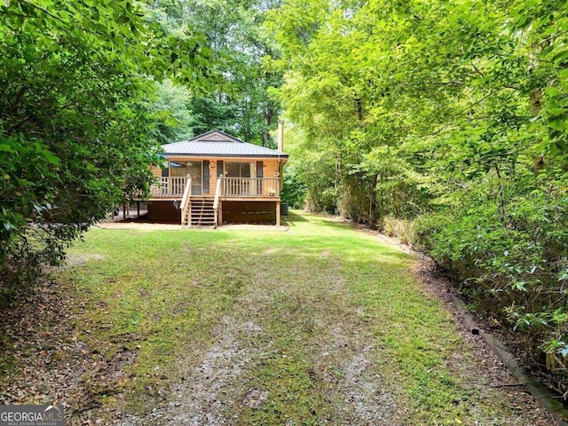 view of yard with a wooded view and stairs