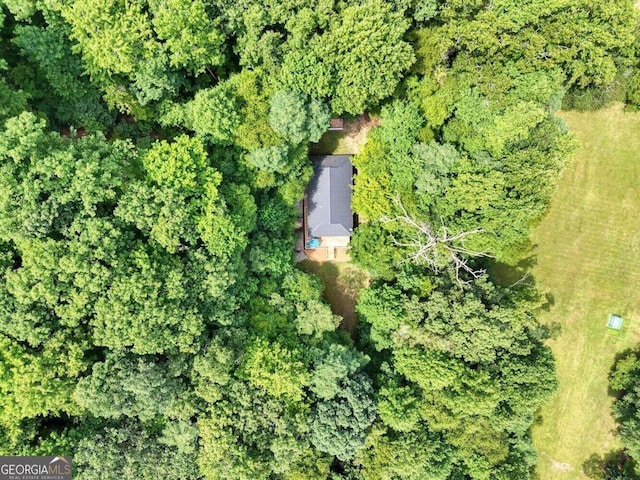 drone / aerial view with a wooded view