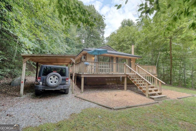 exterior space featuring a carport, gravel driveway, and stairs