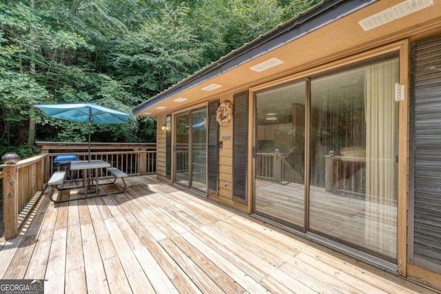 wooden deck featuring outdoor dining space