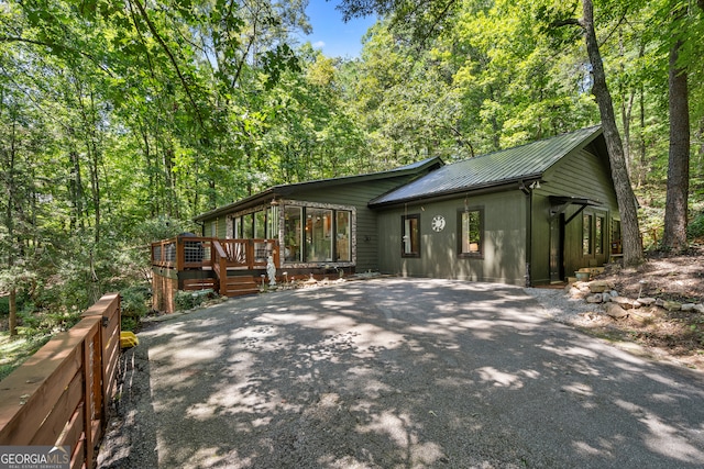 view of property exterior with a deck