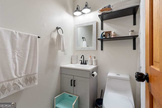 bathroom with toilet and vanity