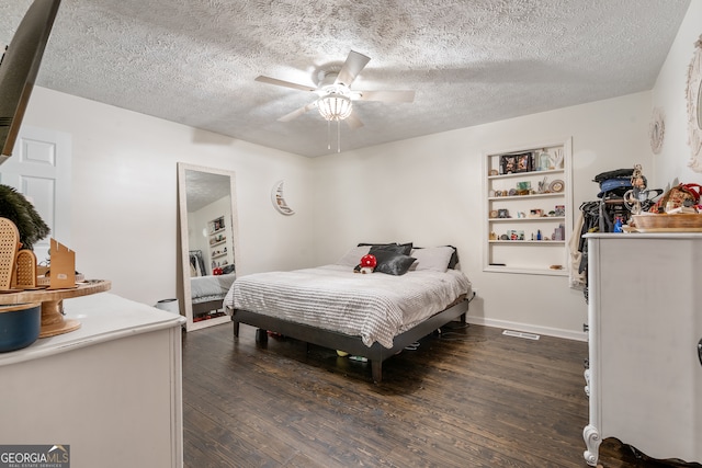 bedroom with ceiling fan, dark hardwood / wood-style floors, and a textured ceiling