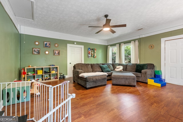 living room featuring a textured ceiling, ceiling fan, and hardwood / wood-style flooring