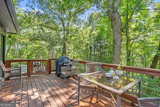 wooden deck featuring a grill