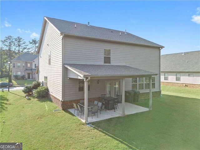 back of property featuring a patio and a yard