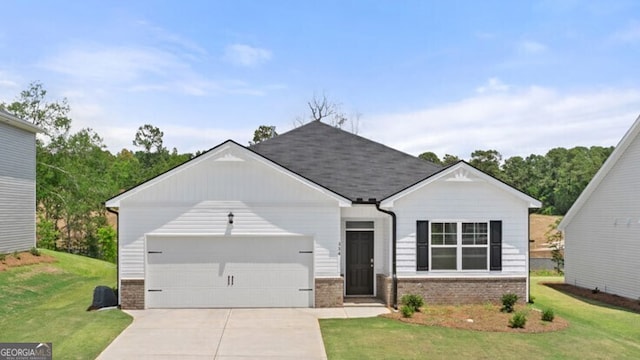 view of front of home with a front yard and a garage