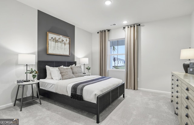 bedroom with recessed lighting, visible vents, light colored carpet, and baseboards