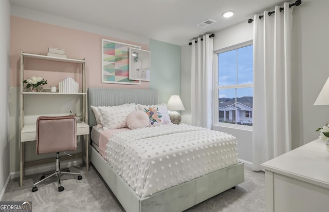 carpeted bedroom featuring visible vents and baseboards