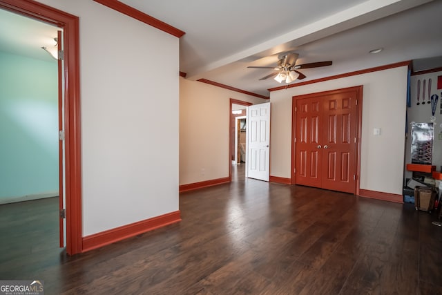 entryway featuring ornamental molding, dark wood-type flooring, and ceiling fan