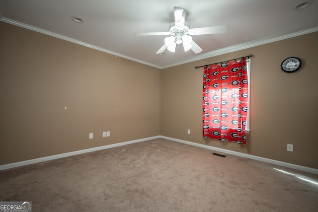 carpeted spare room with ceiling fan and crown molding