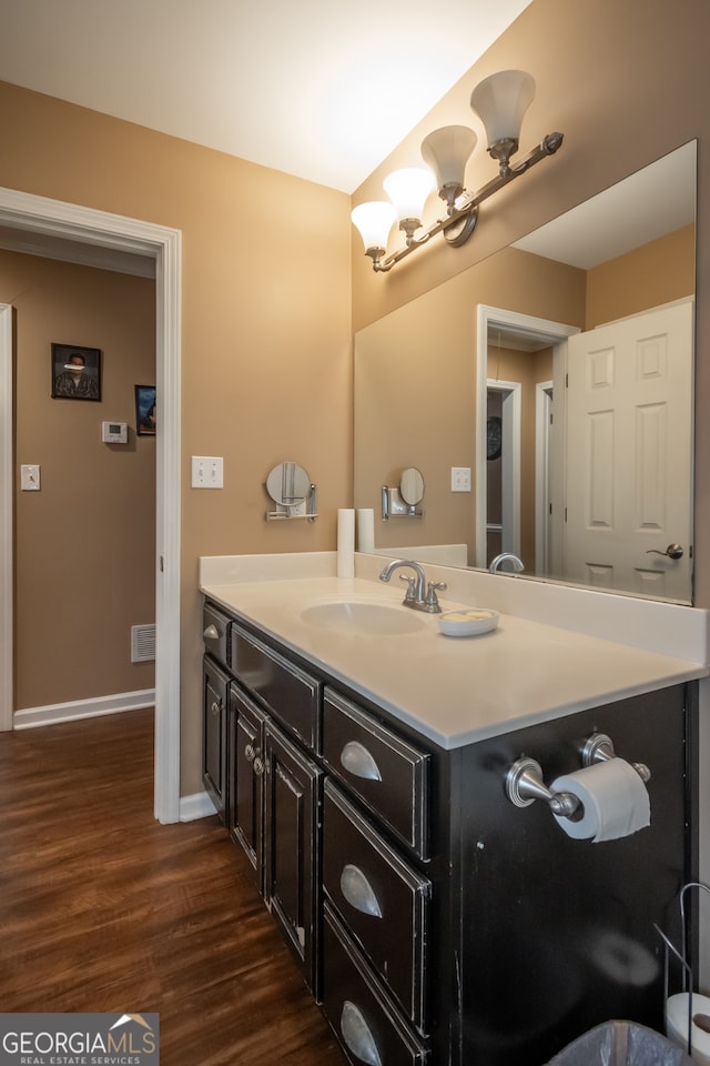 bathroom with hardwood / wood-style floors and vanity