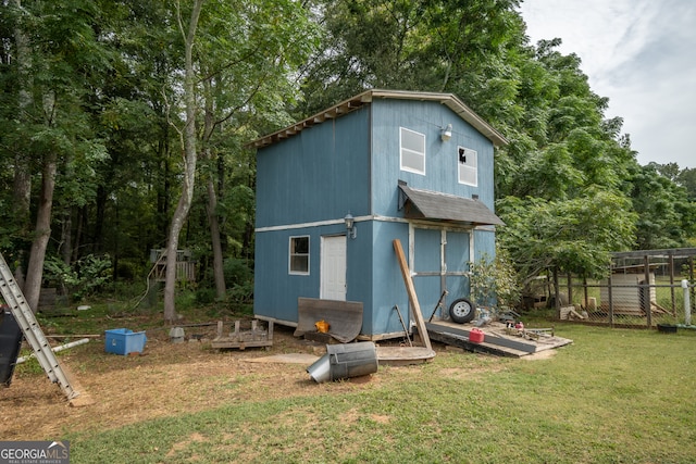 view of outbuilding featuring a lawn