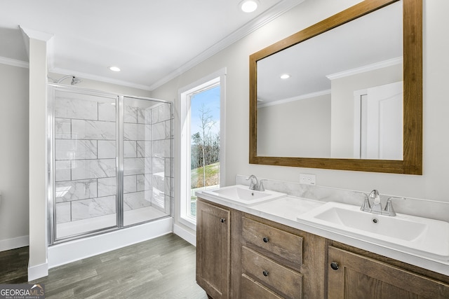 bathroom with vanity, wood-type flooring, an enclosed shower, and ornamental molding