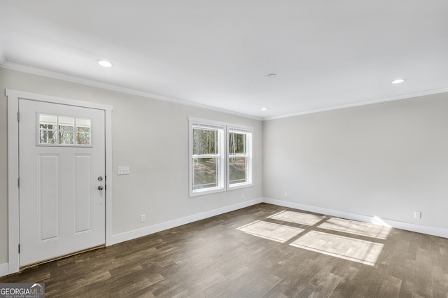 foyer entrance with ornamental molding, dark hardwood / wood-style floors, and a healthy amount of sunlight