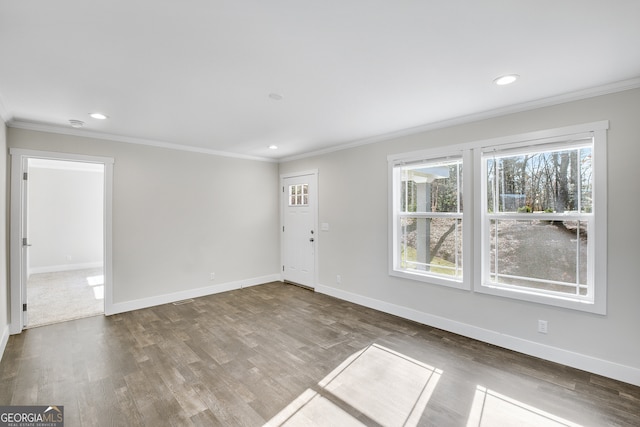 empty room with hardwood / wood-style floors and ornamental molding