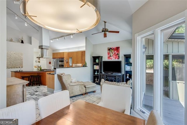 living room with high vaulted ceiling, ceiling fan, and track lighting