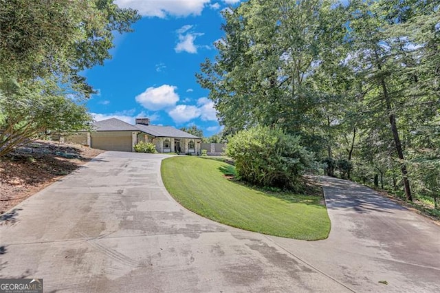 ranch-style home featuring a front yard and a garage