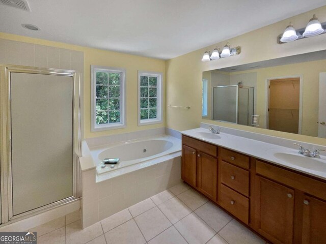 bathroom featuring plus walk in shower, tile patterned floors, and vanity