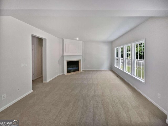 unfurnished living room featuring light carpet