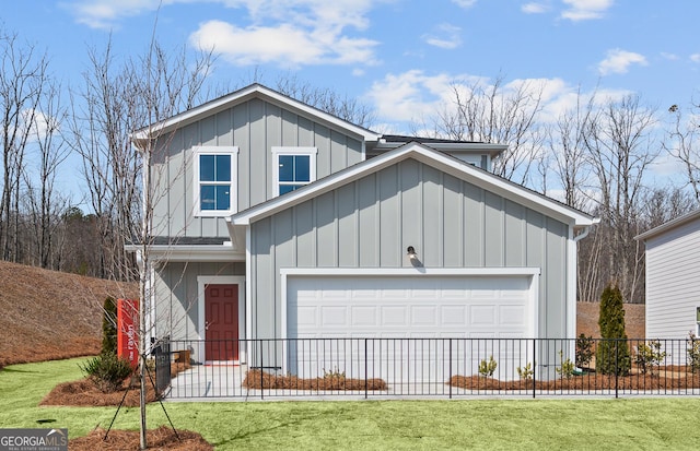 view of front of house with a garage, board and batten siding, a front lawn, and fence