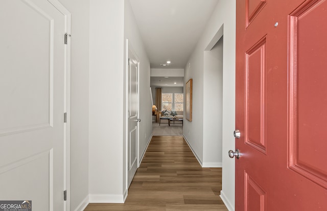 corridor with wood-type flooring