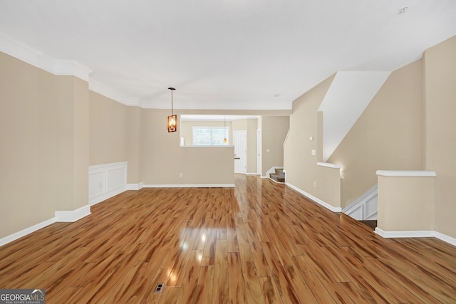 interior space featuring ornamental molding and hardwood / wood-style flooring