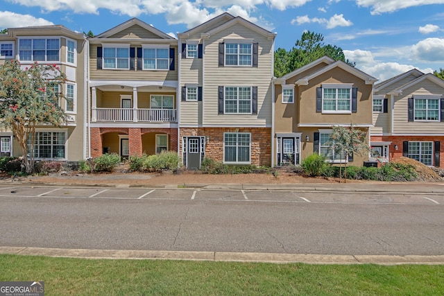 townhome / multi-family property with brick siding