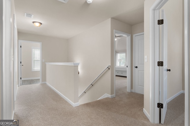 hallway featuring light carpet