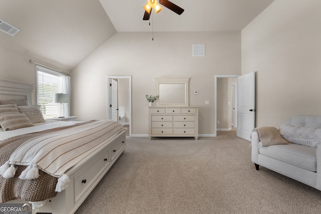 carpeted bedroom featuring high vaulted ceiling, ensuite bathroom, and ceiling fan