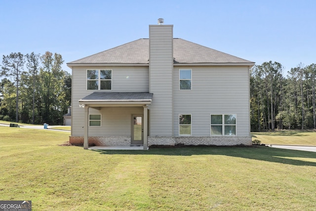 back of house featuring a yard