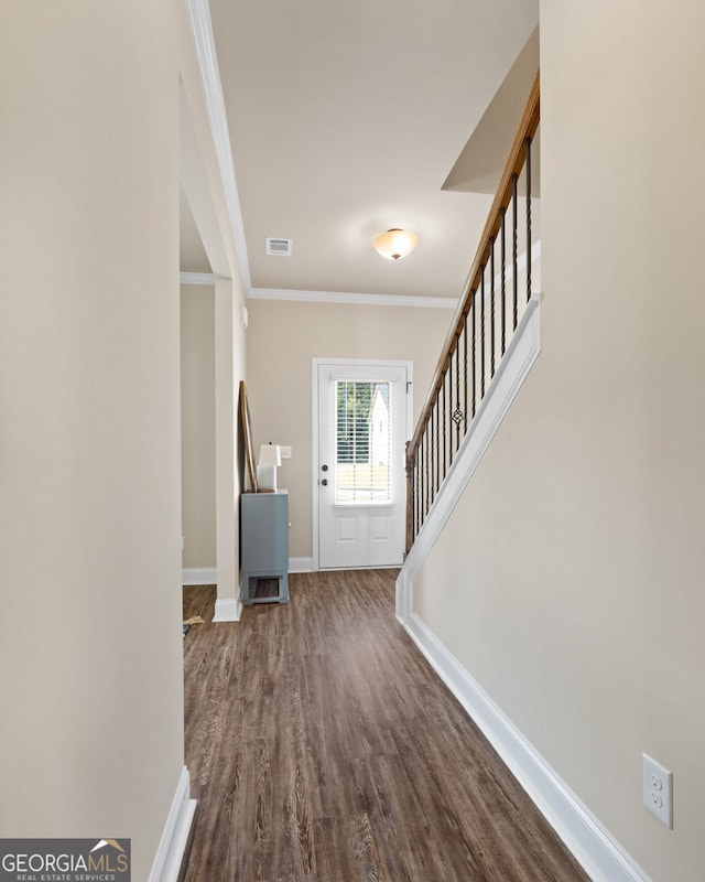 foyer entrance featuring wood-type flooring and crown molding