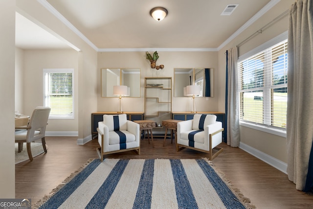 living area featuring crown molding, dark hardwood / wood-style flooring, and a wealth of natural light