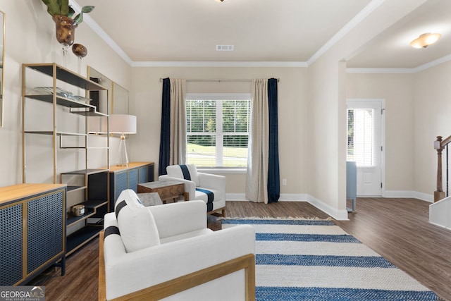 interior space with dark hardwood / wood-style floors, crown molding, and a healthy amount of sunlight