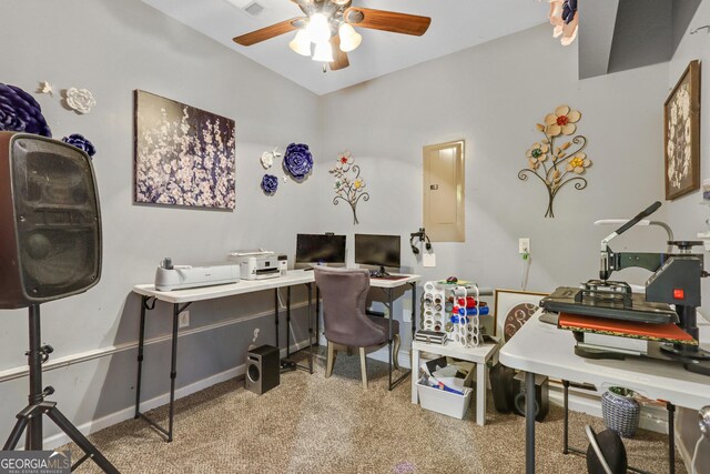 carpeted home office featuring ceiling fan and electric panel