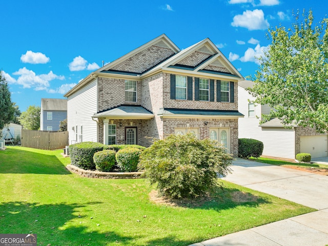 view of front of property featuring a garage and a front lawn