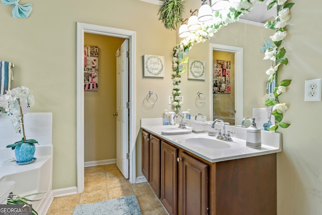 bathroom featuring vanity, ornamental molding, tile patterned floors, and a tub