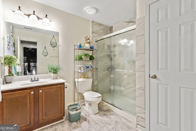 bathroom featuring an enclosed shower, toilet, and vanity