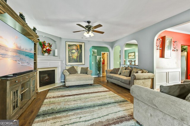 living room featuring dark wood-type flooring and ceiling fan