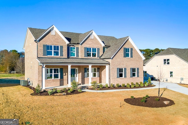 craftsman-style house featuring central AC unit, a porch, and a front yard