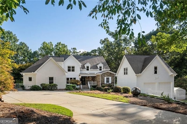 1095 Mockingbird Ln, Cumming, GA 30041 - view of front of home with stone siding, driveway, and an attached garage