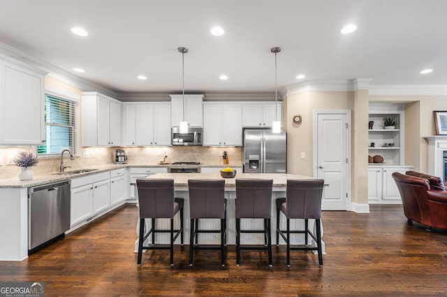 kitchen with a kitchen island, stainless steel appliances, dark hardwood / wood-style floors, and sink