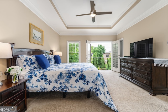 carpeted bedroom featuring crown molding, a raised ceiling, access to outside, and ceiling fan