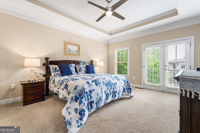 bedroom with access to exterior, ceiling fan, light carpet, and a tray ceiling